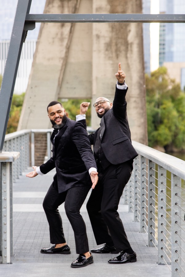 Dancing and pointing to the sky on the bridge in tuxedos